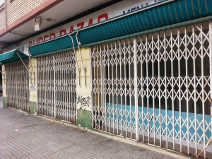 A closed down shop with graffiti on the walls